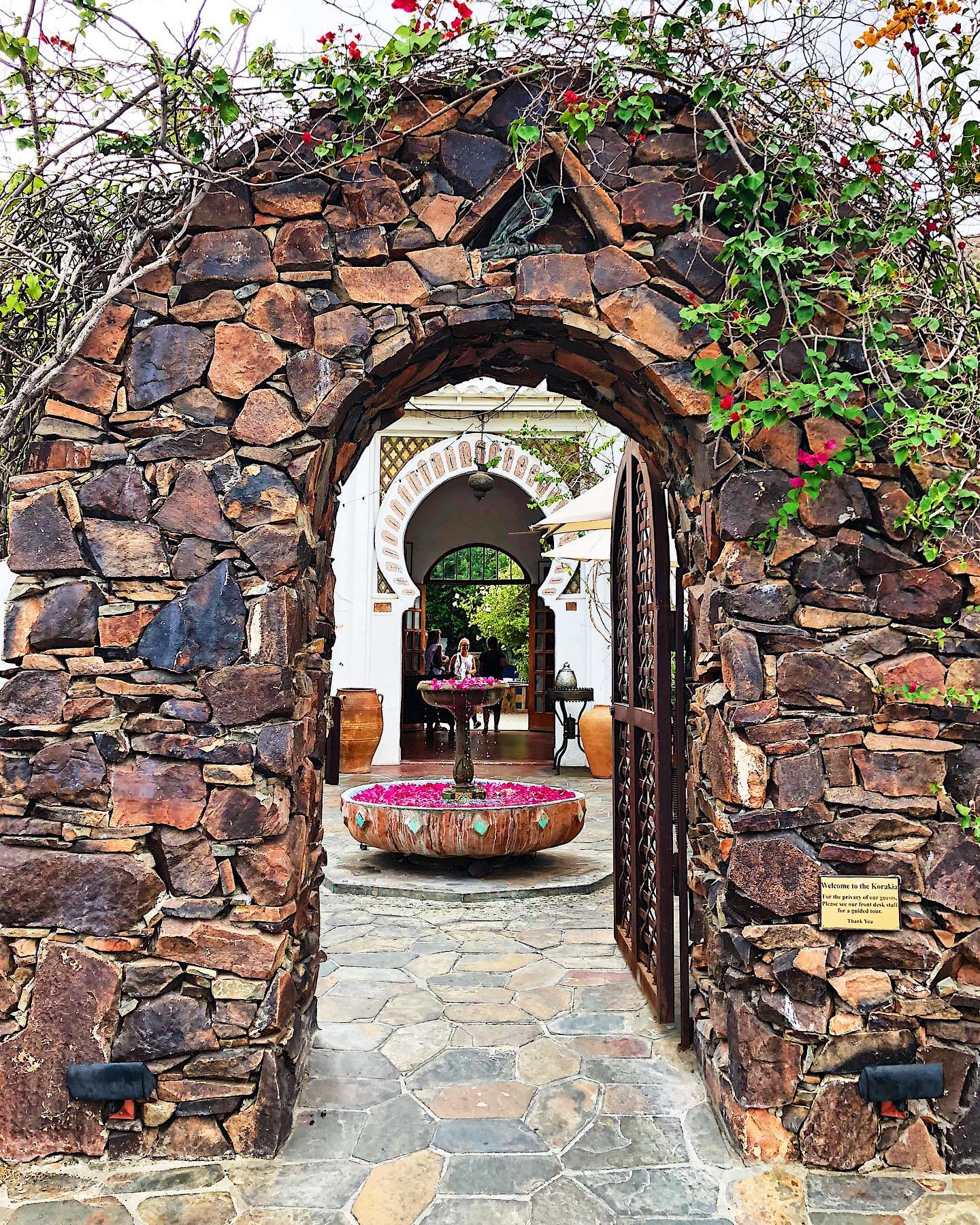 Stone arch gate with rose petal fountain, Villa Korakis